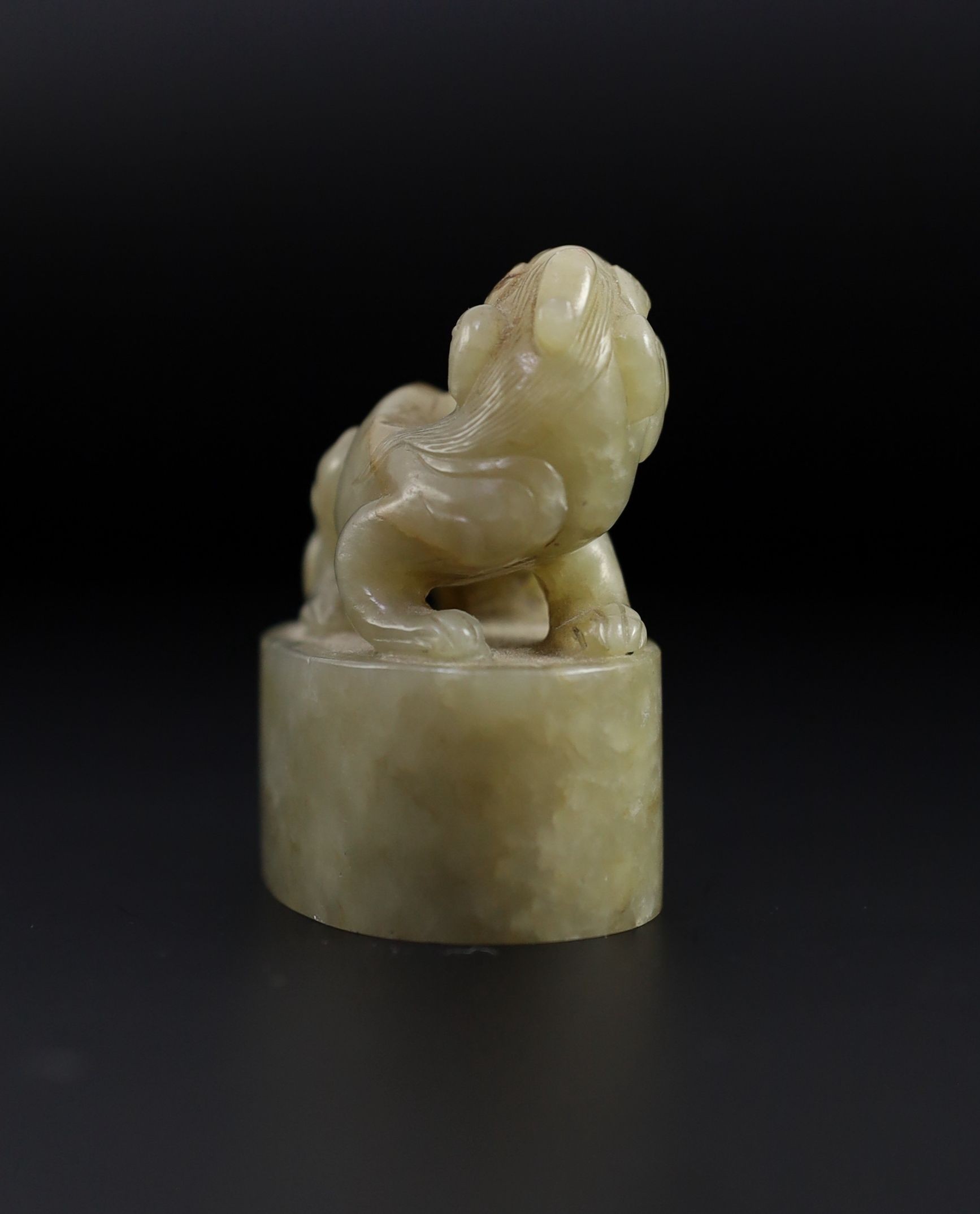 A Chinese celadon and white mottled jade ‘lion-dog’ seal, 18th/19th century, 6cm long